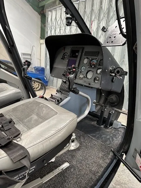 View of the cockpit showing the instrument panel and pilot's seat.