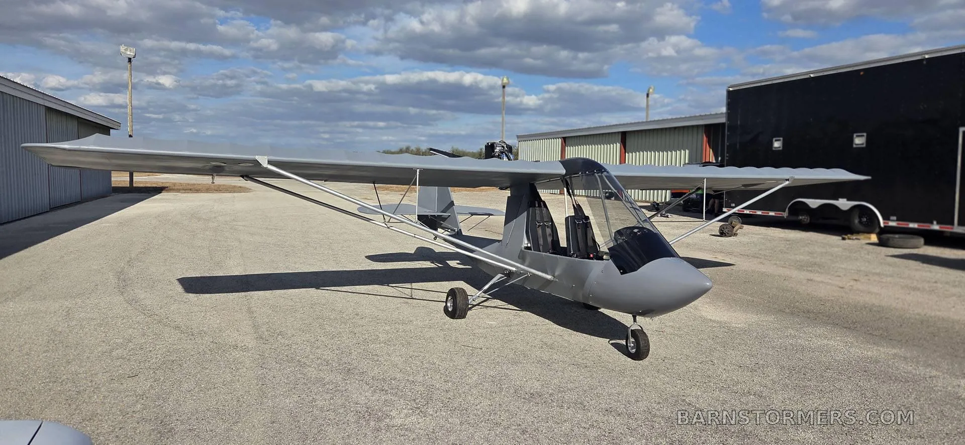 A gray aircraft parked on the tarmac.