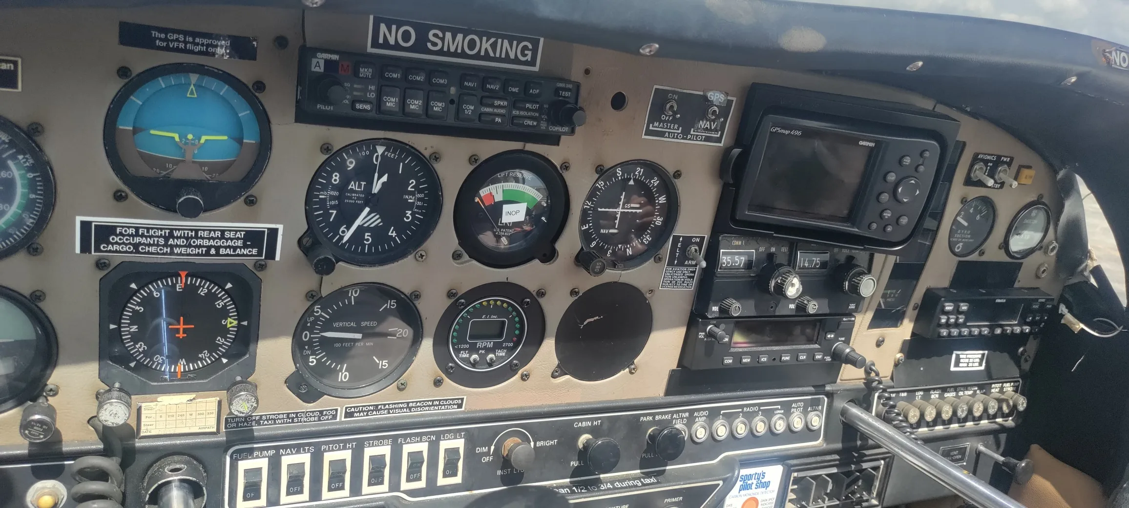 The instrument panel of a Gulfstream American aircraft, showing various gauges, controls, and a Garmin GPS unit.