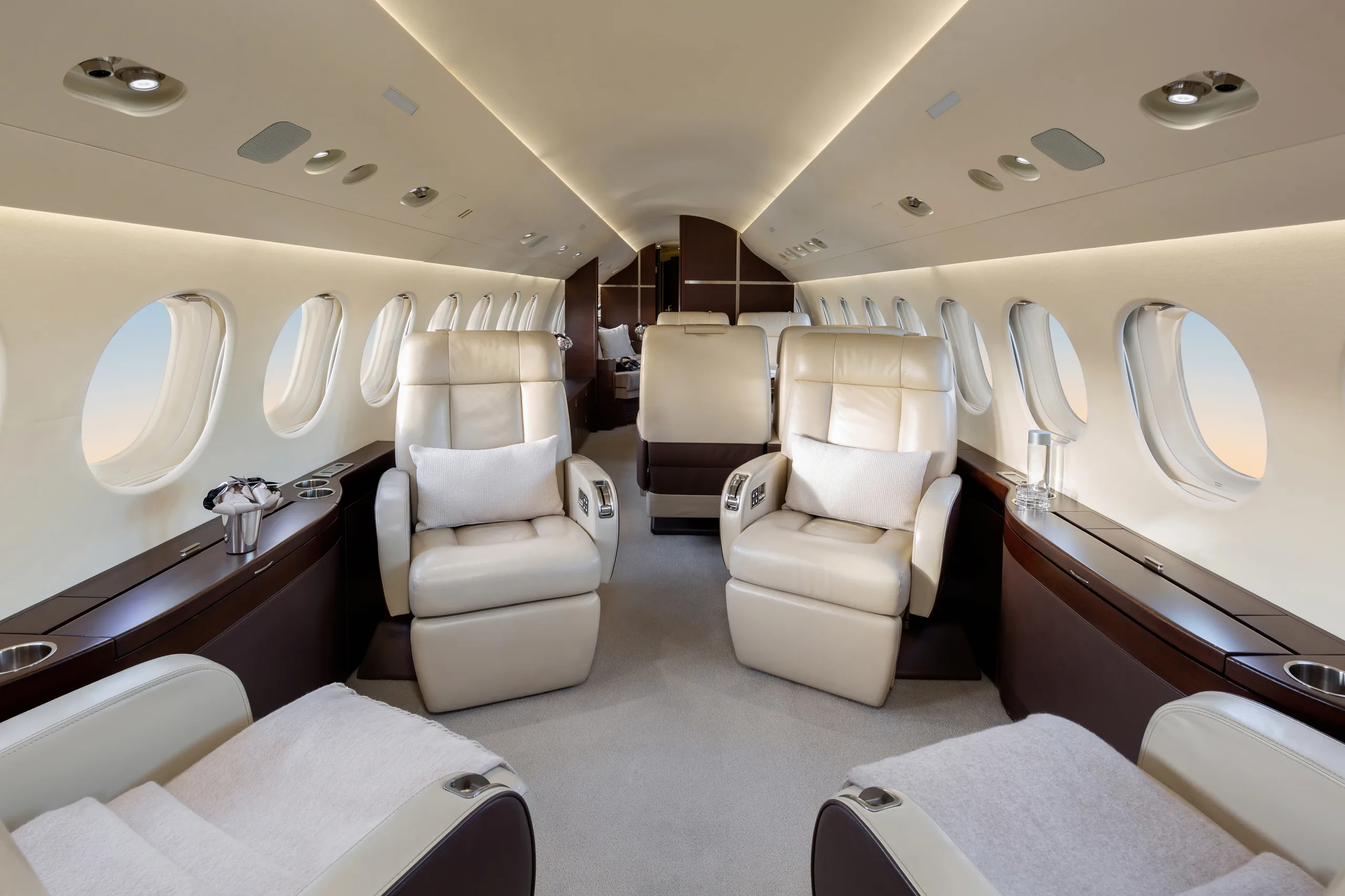 A view of the interior of a Falcon jet with leather seats.
