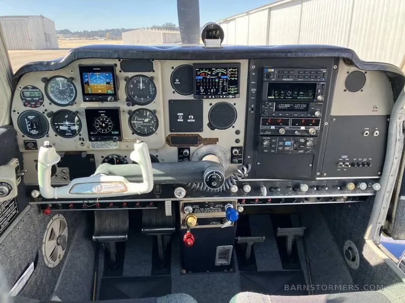 The cockpit instrument panel of an aircraft, featuring various gauges, screens, and controls.