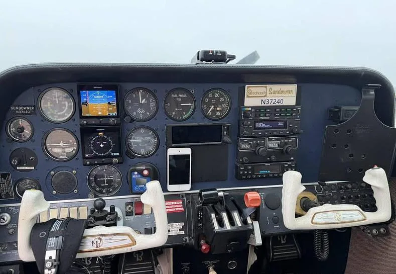 A close-up view of the Beechcraft Sundowner N37240 instrument panel with various gauges and avionics.