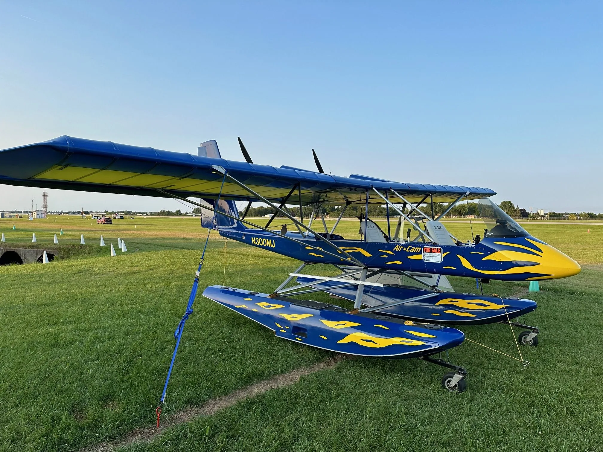 Air-Cam N300MJ on floats parked on the grass.
