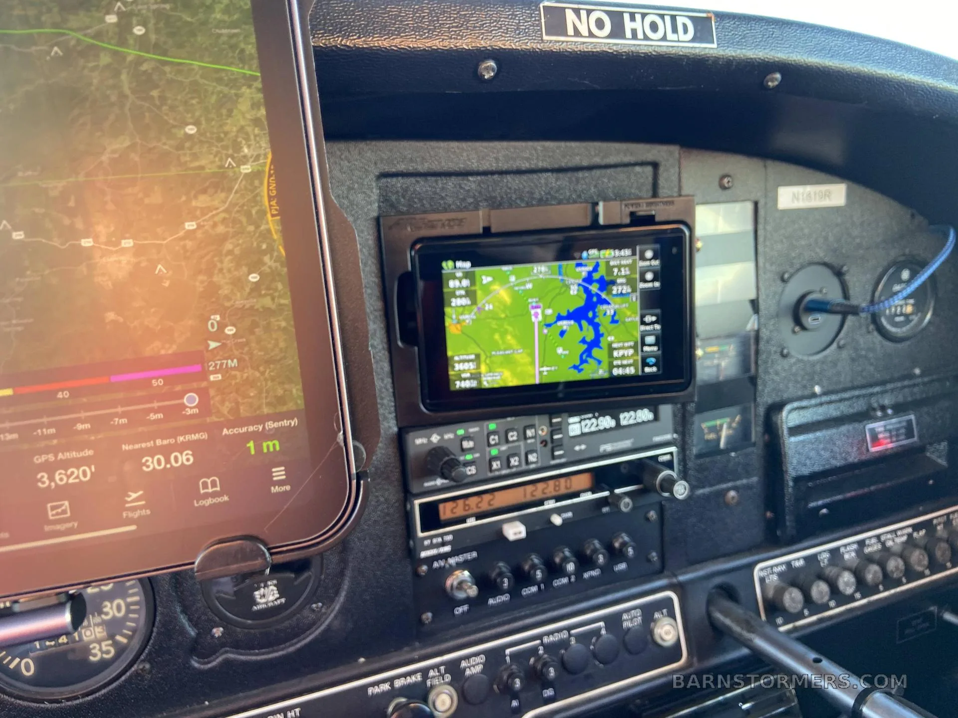 A close-up view of an aircraft cockpit with multiple screens displaying navigation information.