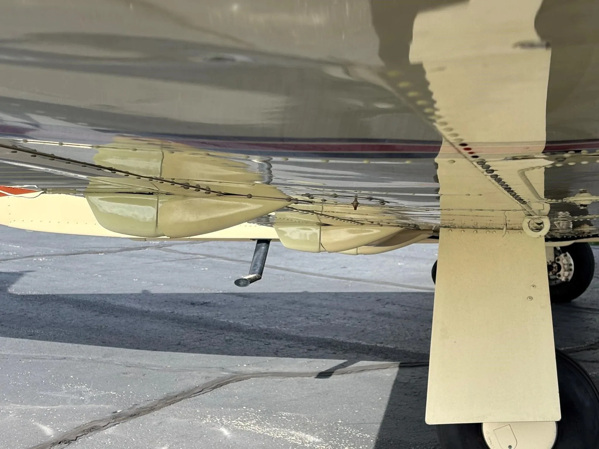 An underside view of the aircraft showing the landing gear and belly.