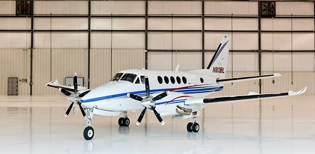 A Beechcraft King Air 350 is parked inside a hangar.