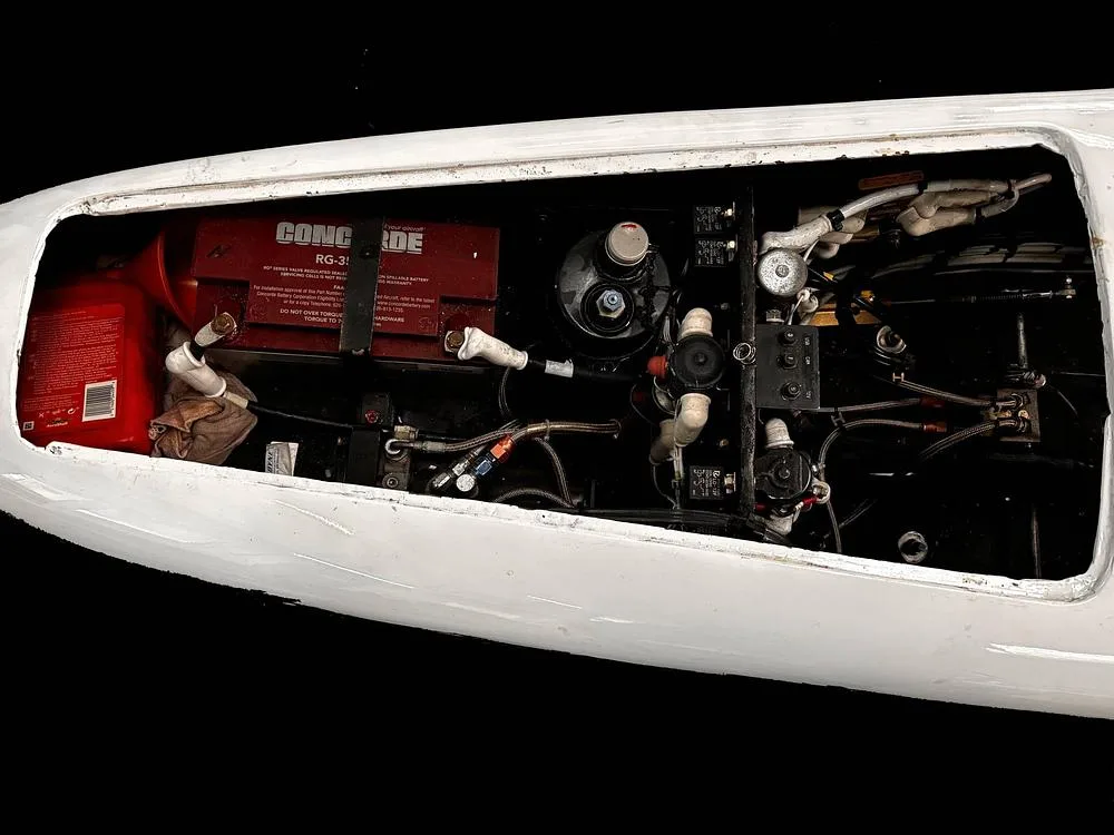An open compartment of the aircraft shows a red Concorde RG-35 battery and other internal systems.