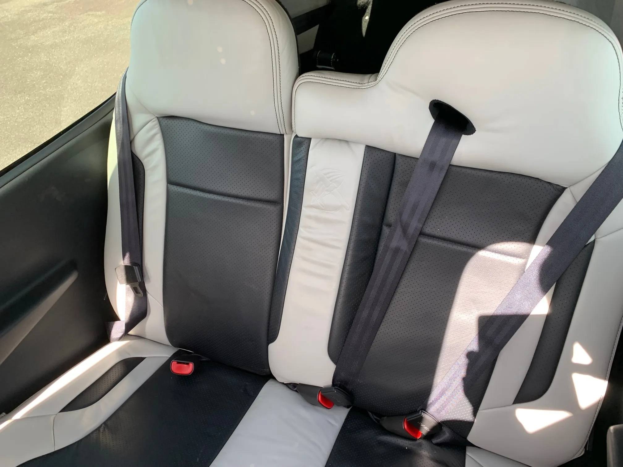 The black and white leather rear seats of a Cirrus SR22T aircraft cabin.