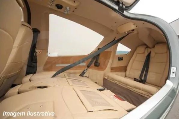 A view of the beige leather interior cabin of a Diamond DA62 aircraft, showing the rear seats.