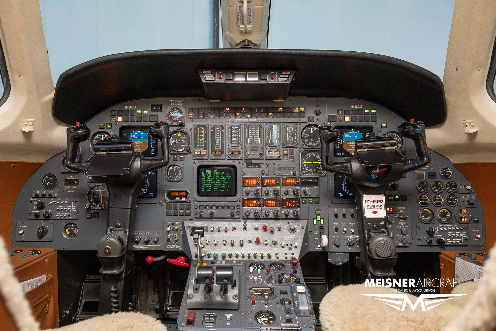 The detailed instrument panel of a Cessna Citation cockpit with multiple screens and controls.