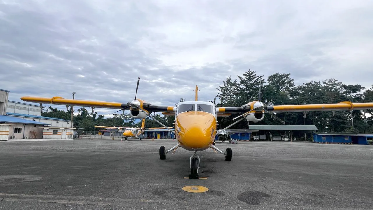 Front view of PK-OCF Twin Otter parked on the tarmac.