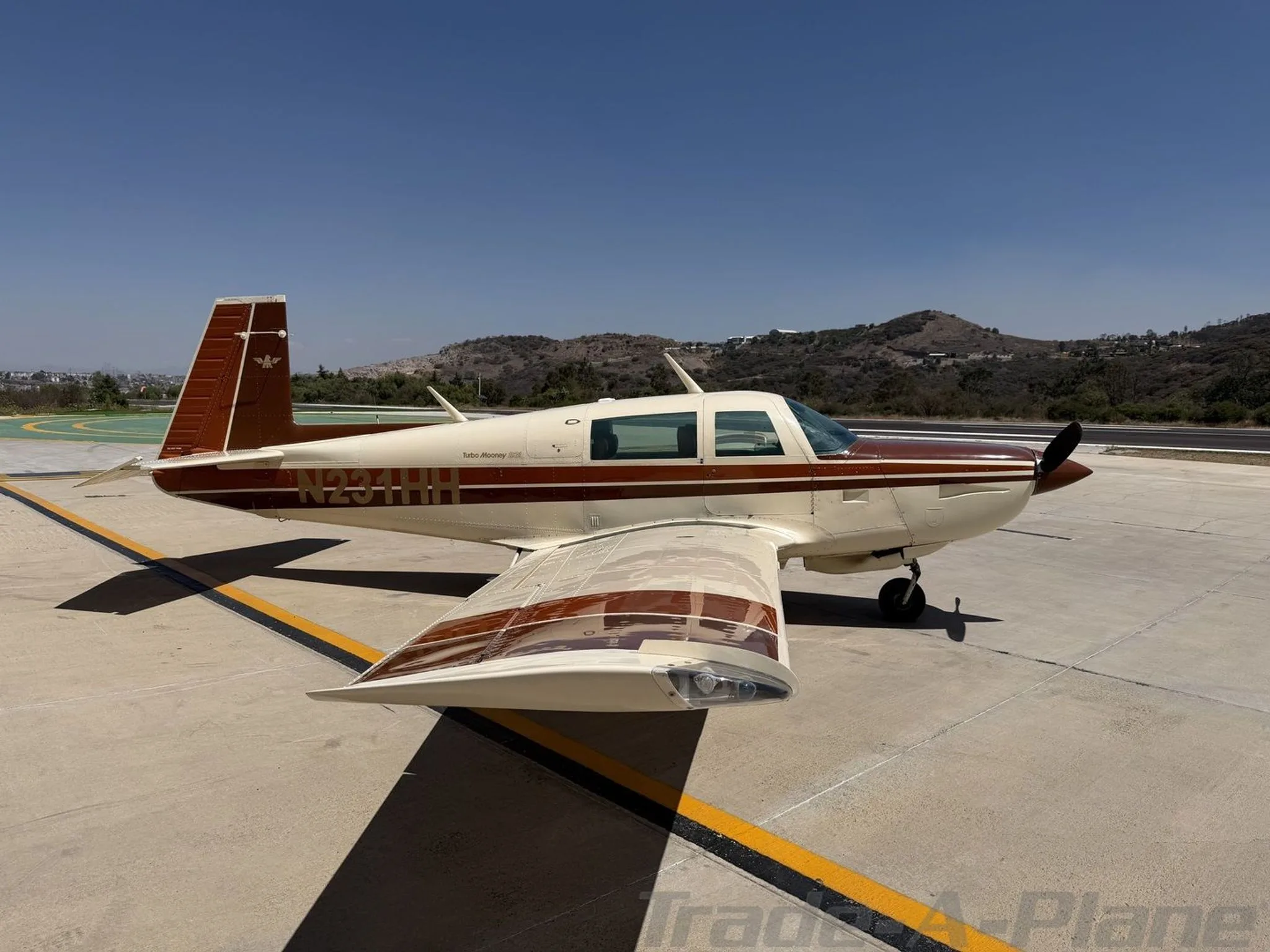 Side view of the Mooney M20K 231 on the tarmac.