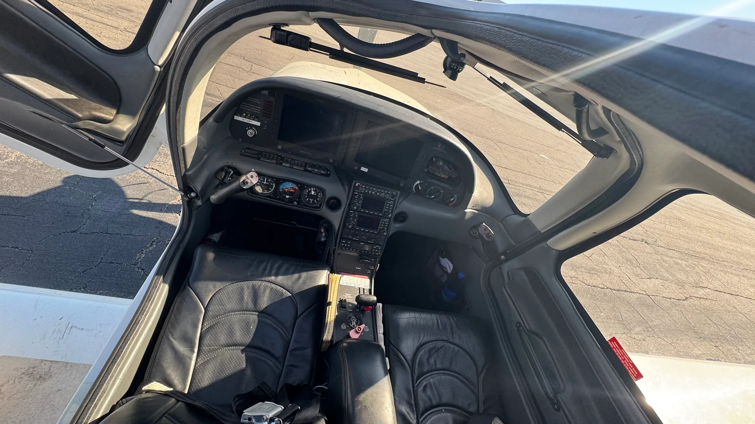 An overhead view of the Cirrus SR22T cockpit with black leather seats and a modern instrument panel.