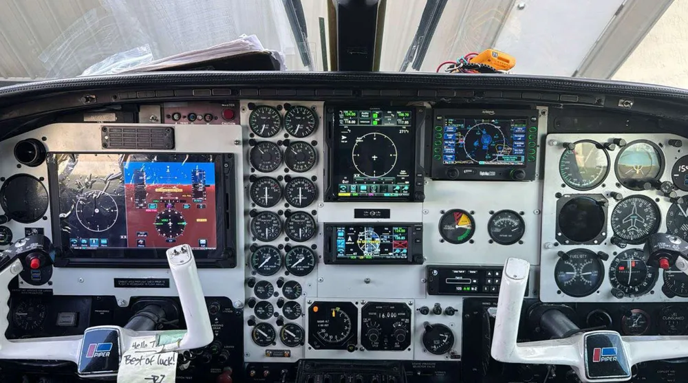 The cockpit of a Piper PA-31 Navajo, featuring a mix of analog gauges and modern digital displays.