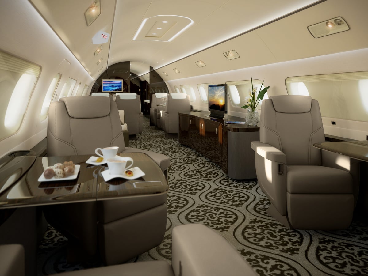 A luxurious jet interior with leather seats and a patterned carpet.