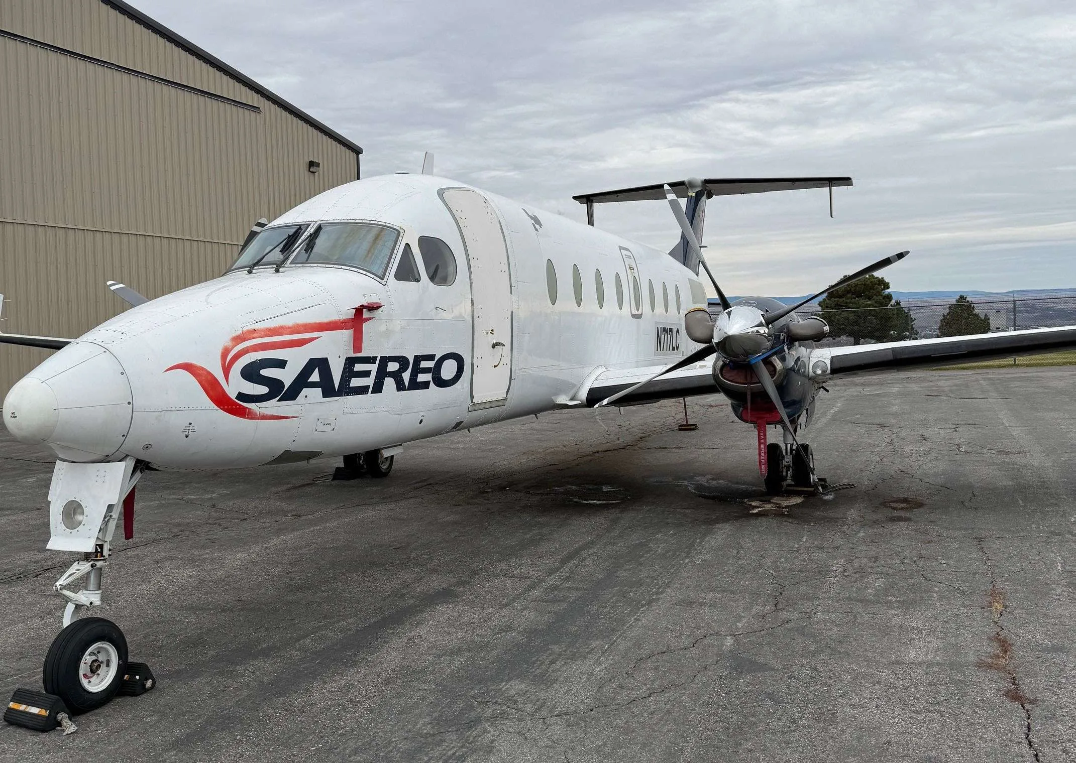 A Beechcraft 1900C with SAEREO livery is parked on the tarmac.