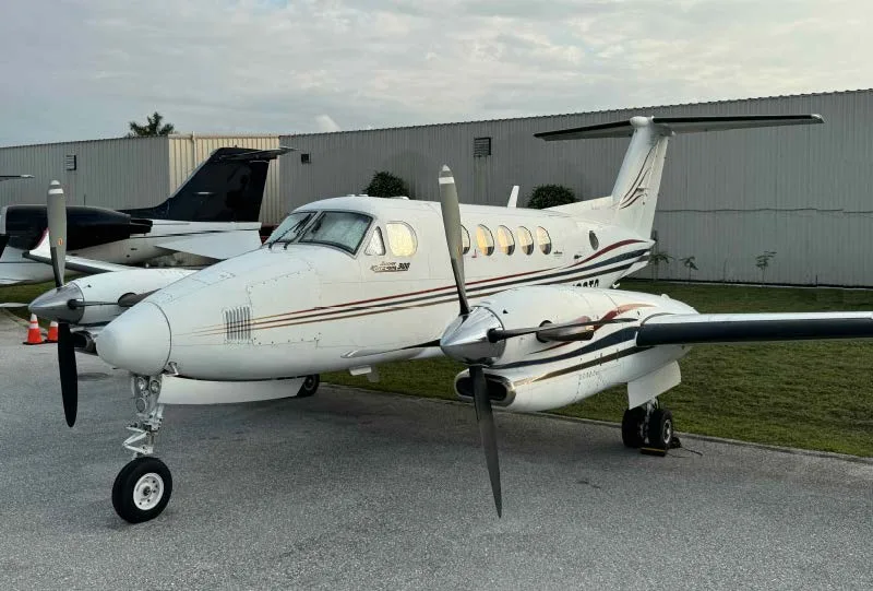A King Air 200 aircraft with registration N66TG parked on the tarmac.