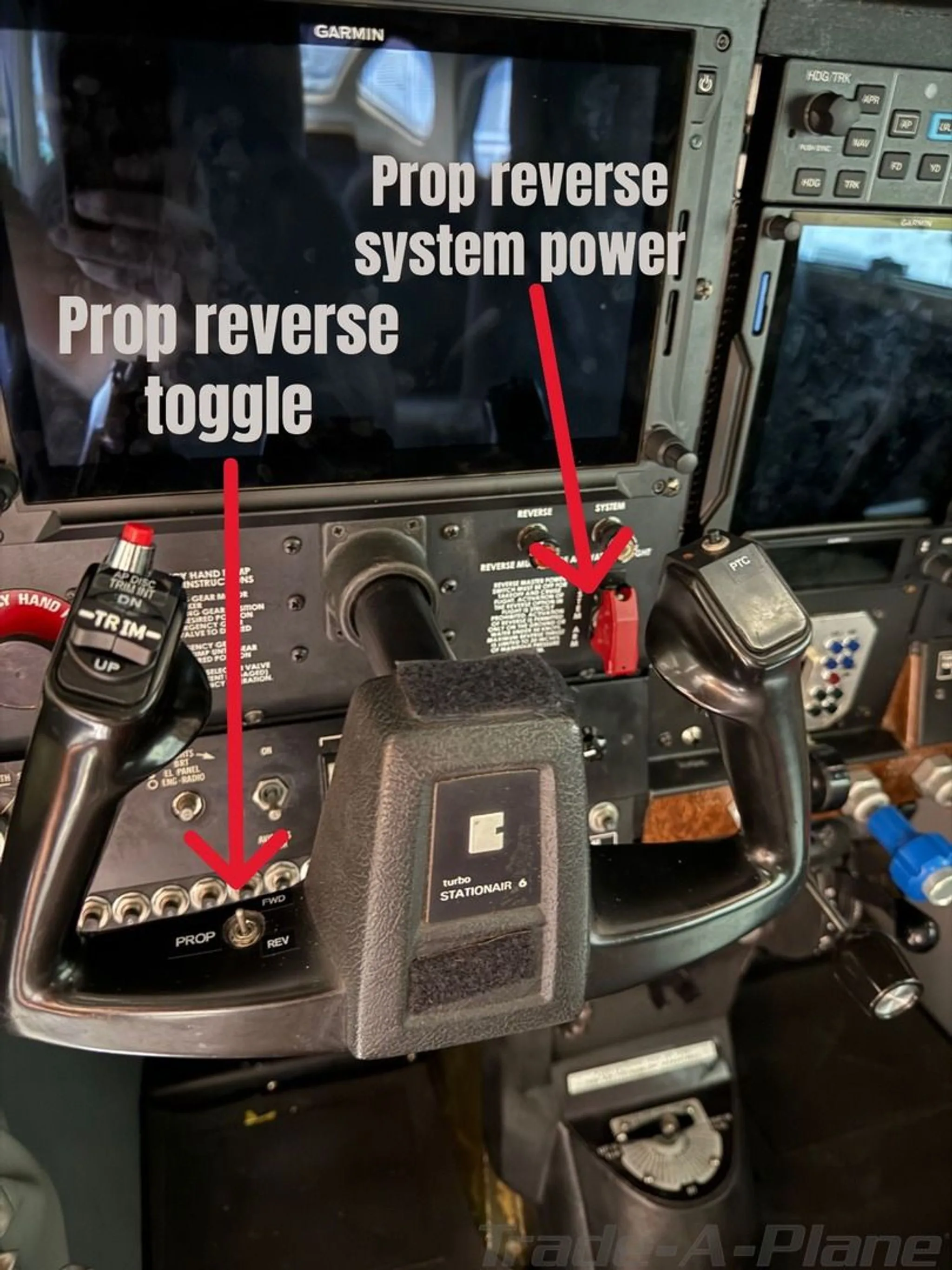 Close-up view of the Cessna 206 Stationair's cockpit controls, highlighting prop reverse system power and toggle.