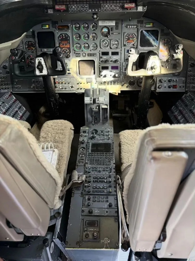 The aircraft's cockpit with a complex array of analog gauges, screens, and controls.