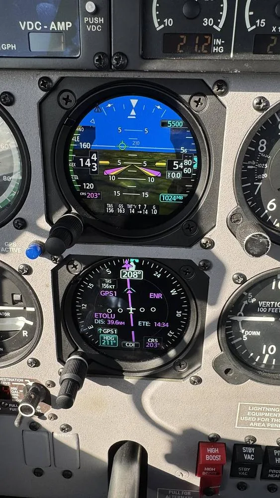 A close-up view of two digital displays in the cockpit, showing flight information and navigation data.
