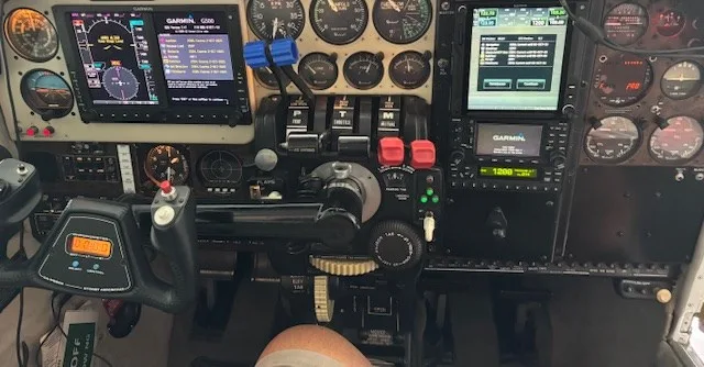 A detailed view of an aircraft cockpit with a Garmin G500 display and various analog gauges.
