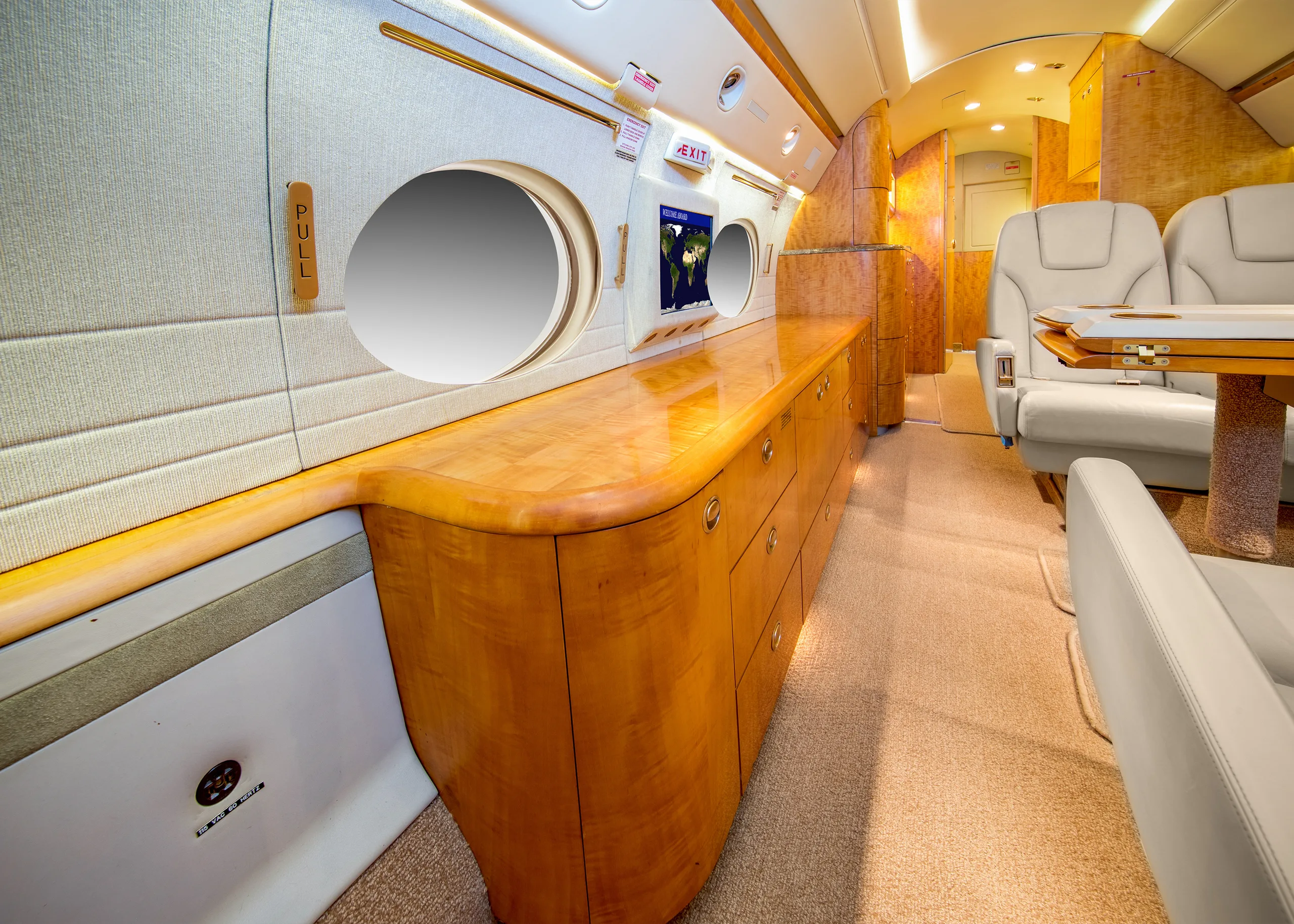 The aircraft's interior features a long cabinet and seating.