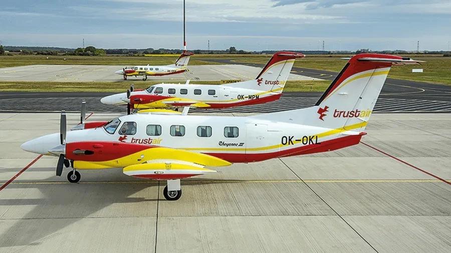 Three Cheyenne III aircraft with Trust Air livery on the tarmac.