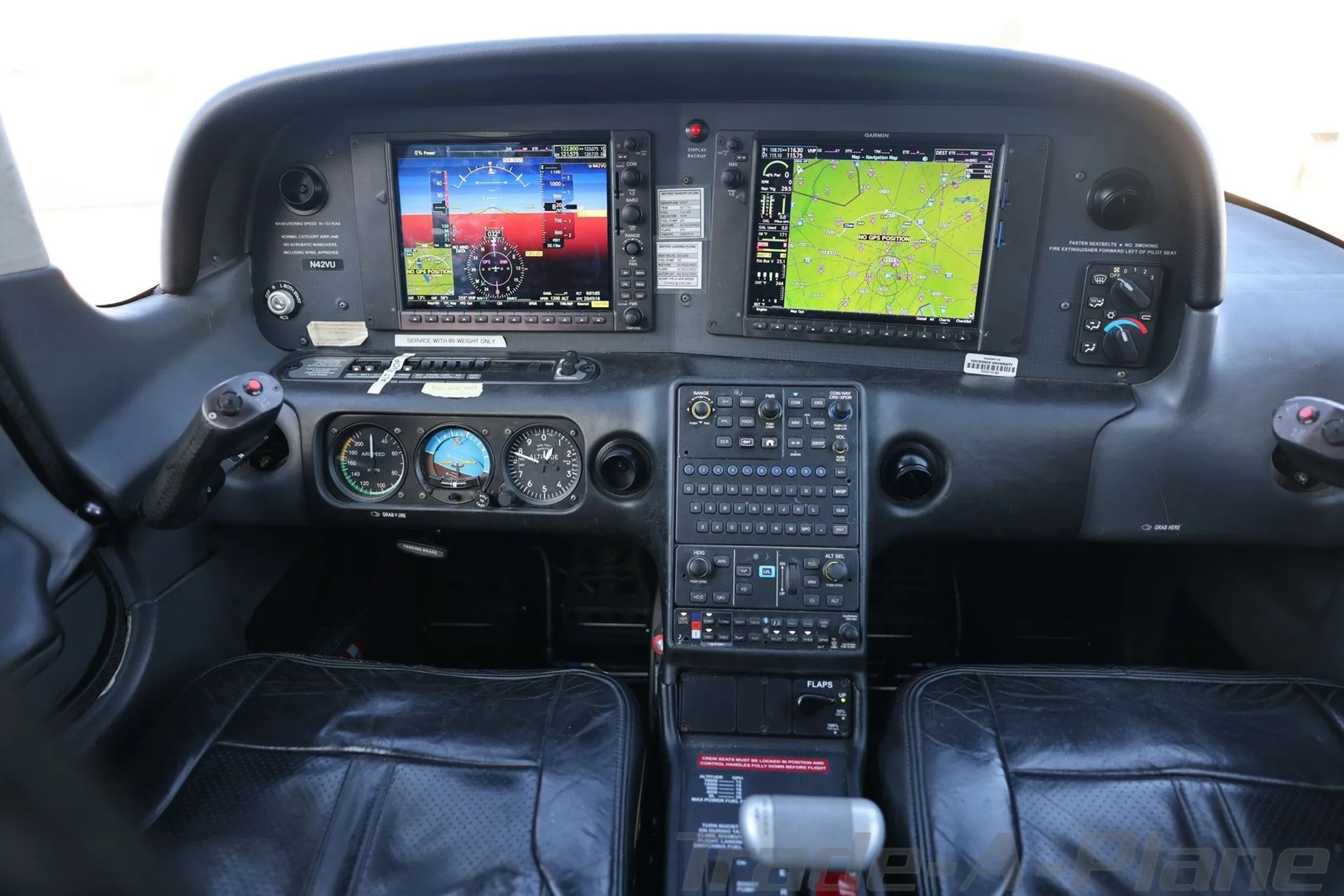 A full view of the aircraft's modern glass cockpit with dual digital displays, traditional gauges, and control panel.