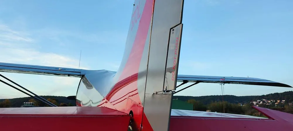 A very close-up view of the red and gray tail section of the N346X aircraft, showing the vertical stabilizer.