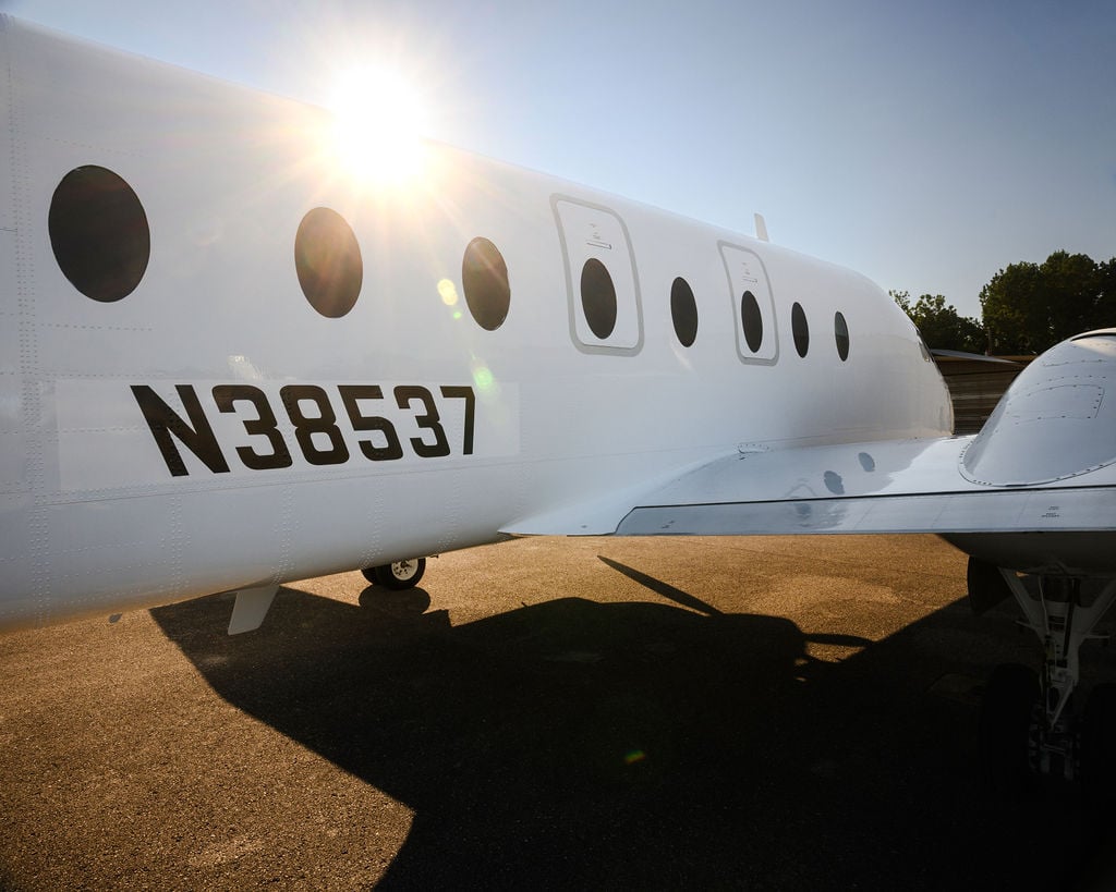 The tail section of a white aircraft with the registration number N38537.