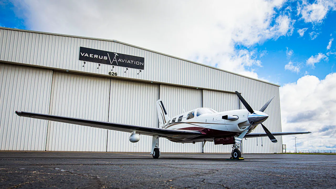 A Meridian aircraft parked on the tarmac in front of a hangar.