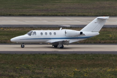 A Cessna Citation aircraft is taxiing on the runway.