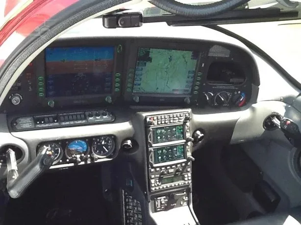 The cockpit of a Cirrus SR22T aircraft, featuring a glass panel display with multiple screens.