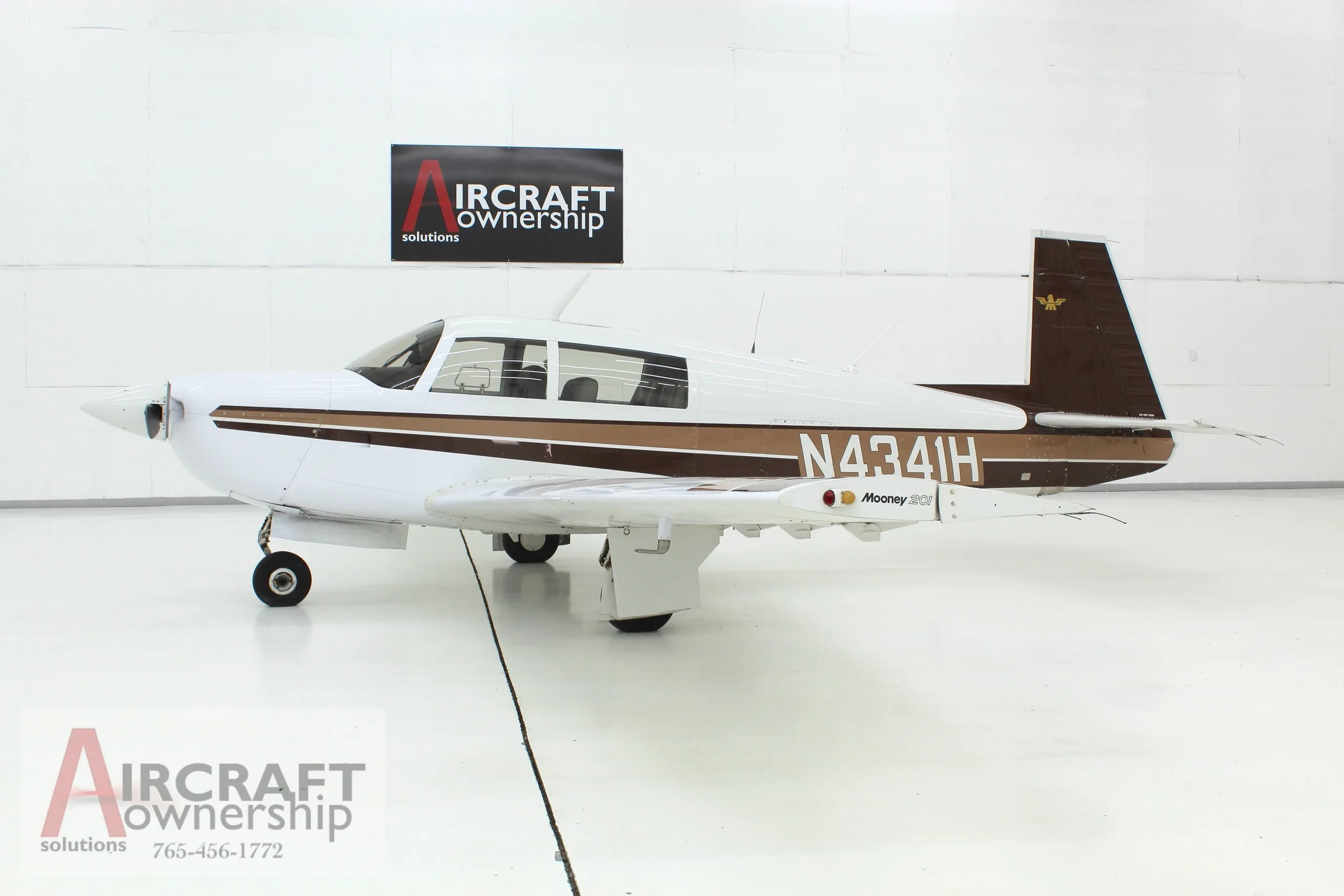 Mooney M20J aircraft with registration N4341H in a hangar.