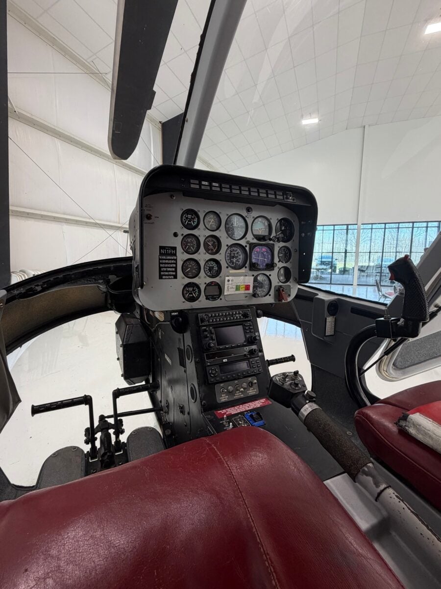 The cockpit of a Bell 206B JetRanger helicopter, showing the instrument panel and controls.