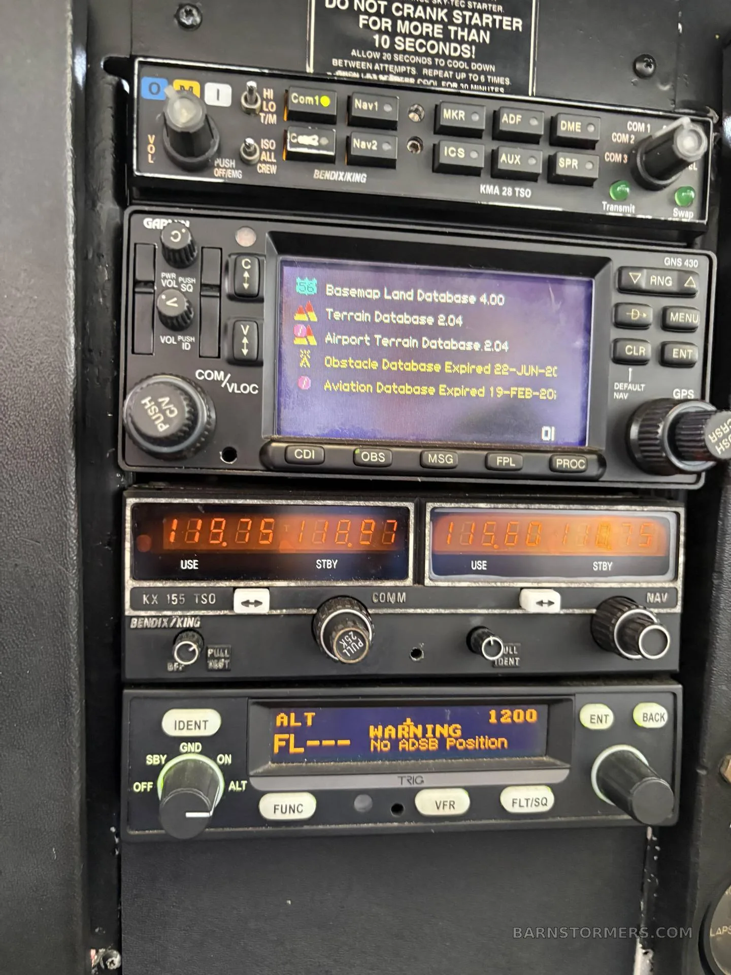 A close-up view of an aircraft's avionics stack, displaying various radios, a GPS unit with database information, and a transponder.