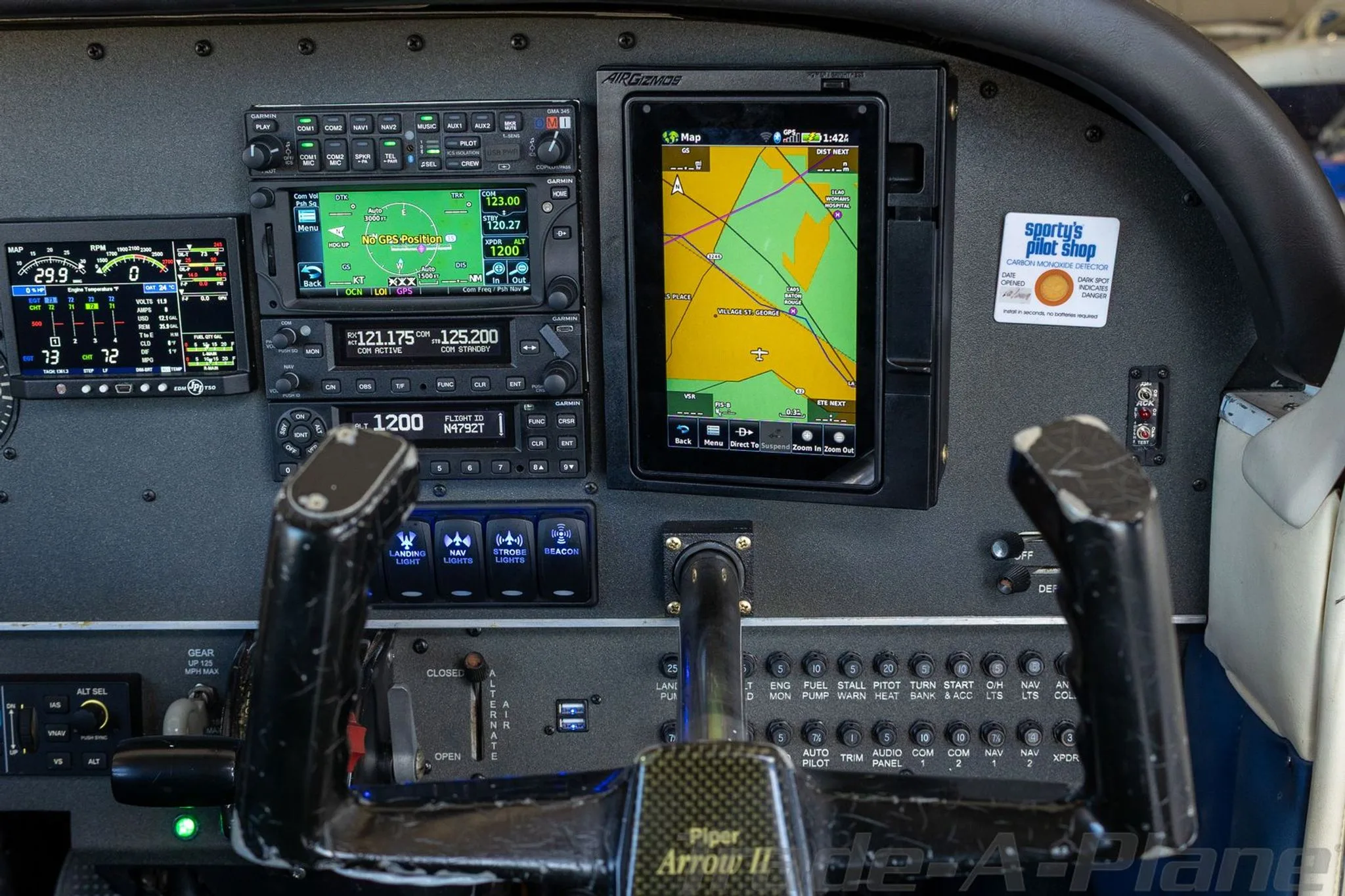 Detailed view of the right side of the Piper Arrow II cockpit panel, showing a large GPS map display and various controls.