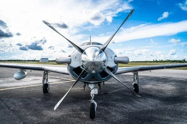 A head-on view of the Piper M500 (Meridian) aircraft, showing its large propeller and nose cone on a tarmac.