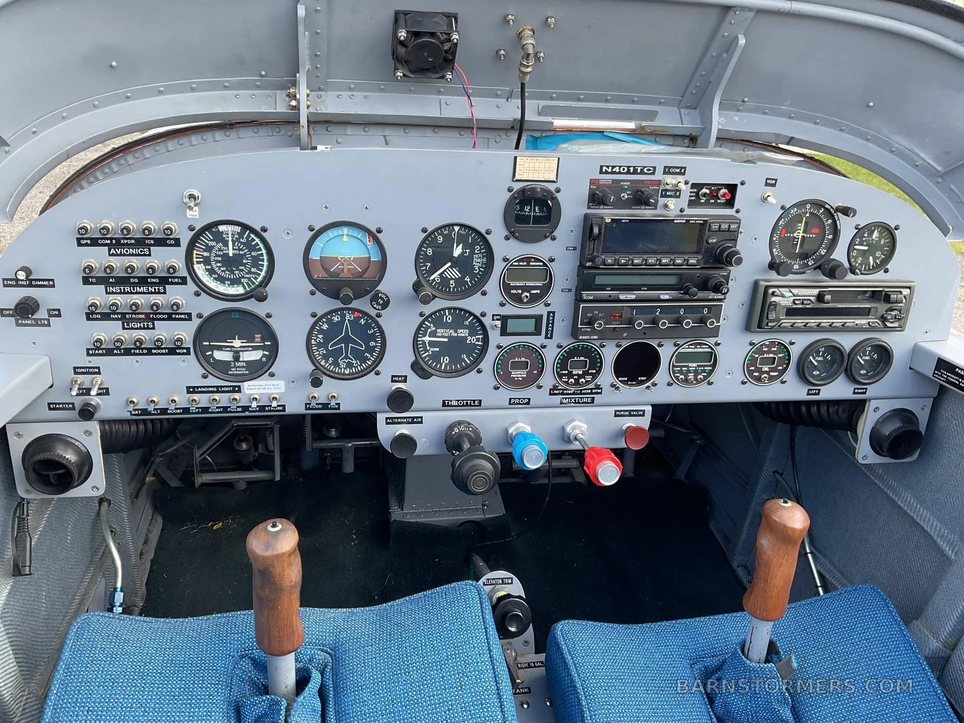 The cockpit of a small aircraft (N401TC), showing the instrument panel with various gauges, radios, and flight controls.