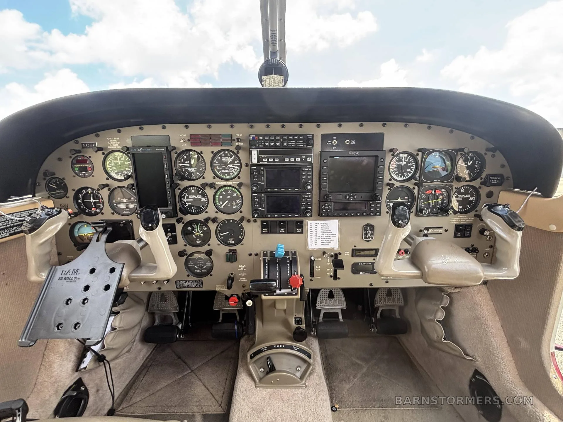 The cockpit of a Piper Saratoga II HP aircraft, showing the instrument panel with various gauges and screens.
