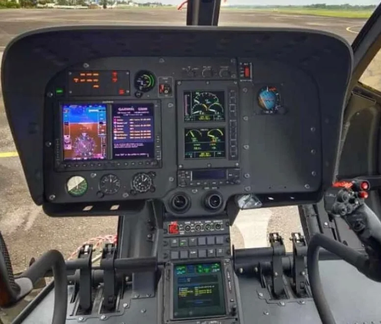 Close-up of the helicopter's instrument panel with multiple displays.