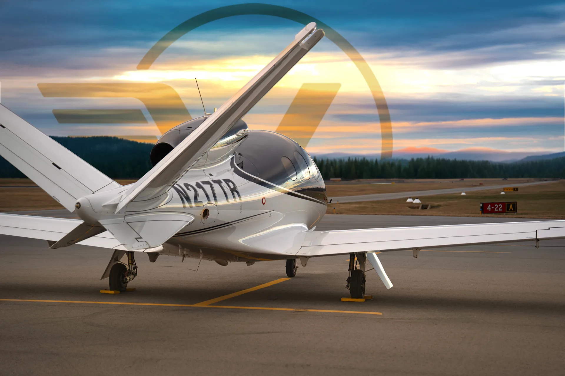Rear quarter view of Cirrus Vision Jet N217TR on the ramp at sunset.