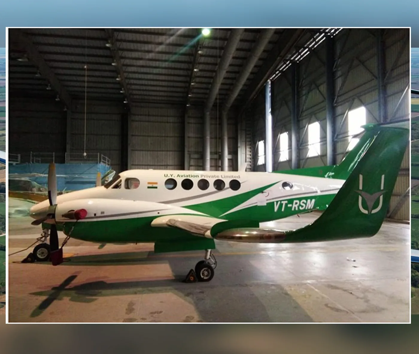 A green and white Beechcraft King Air VT-RSM parked inside a hangar.