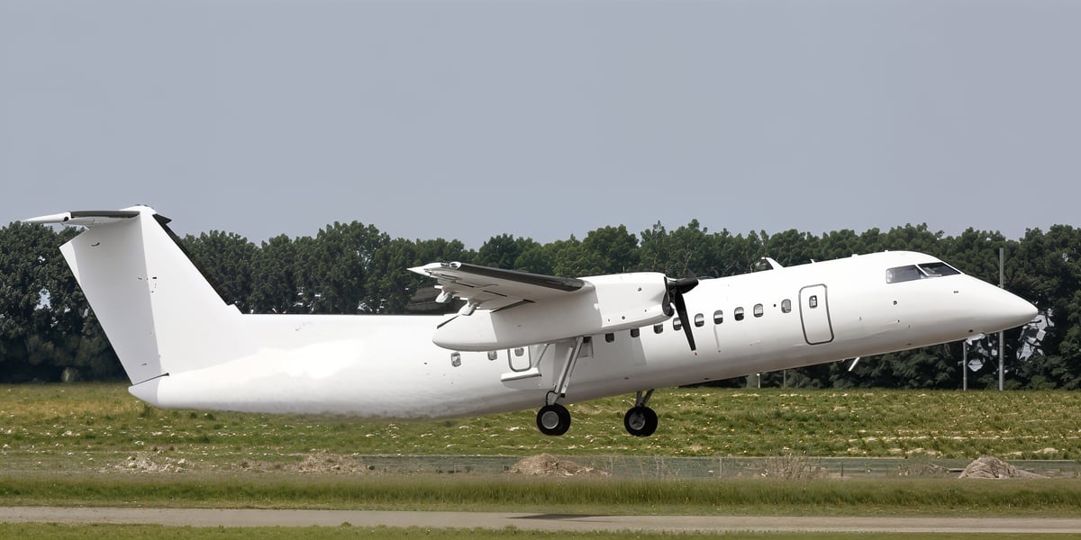 A white Bombardier Dash 8 taking off.