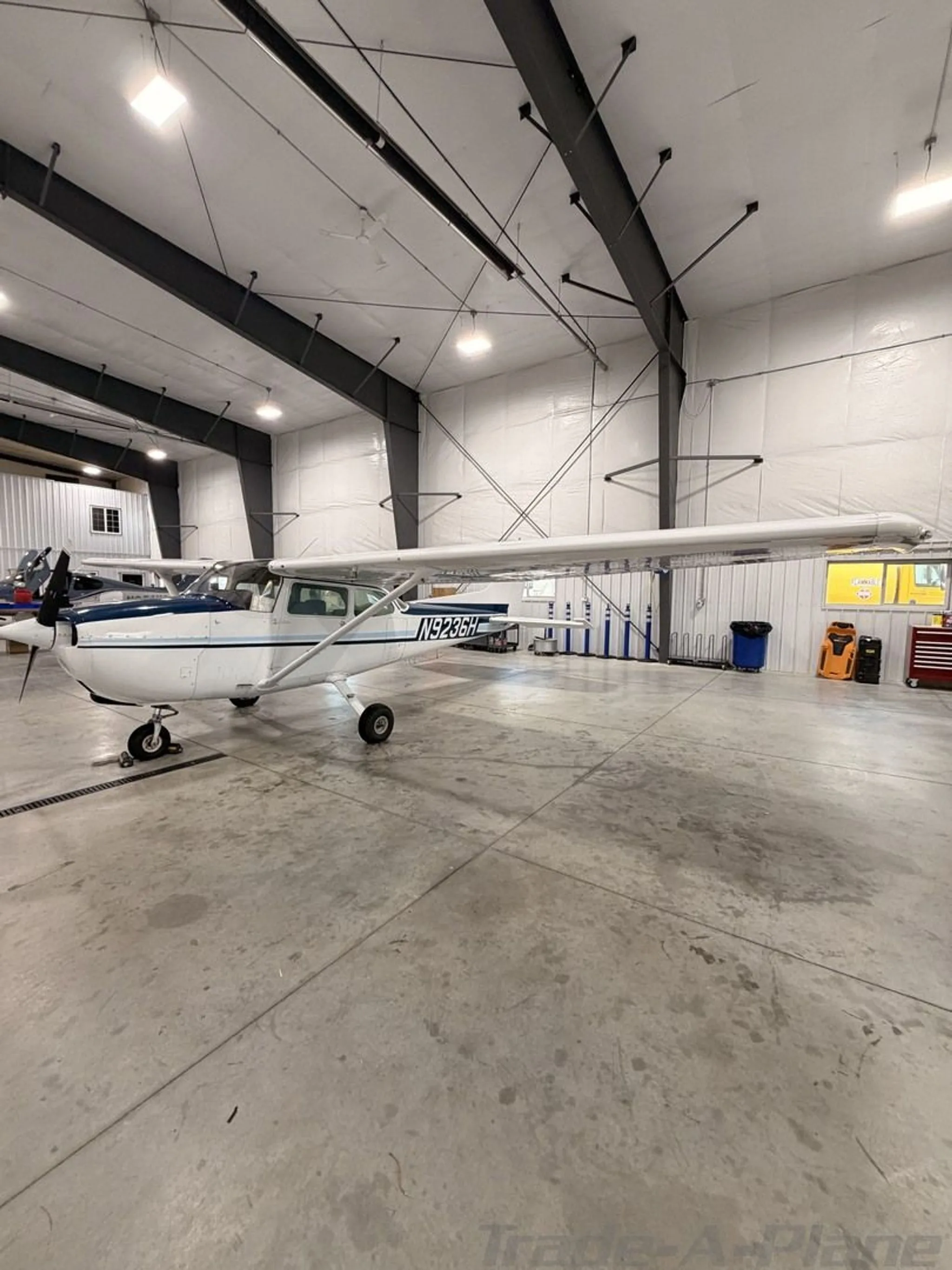 Side profile of the Cessna 172M Skyhawk in a hangar.