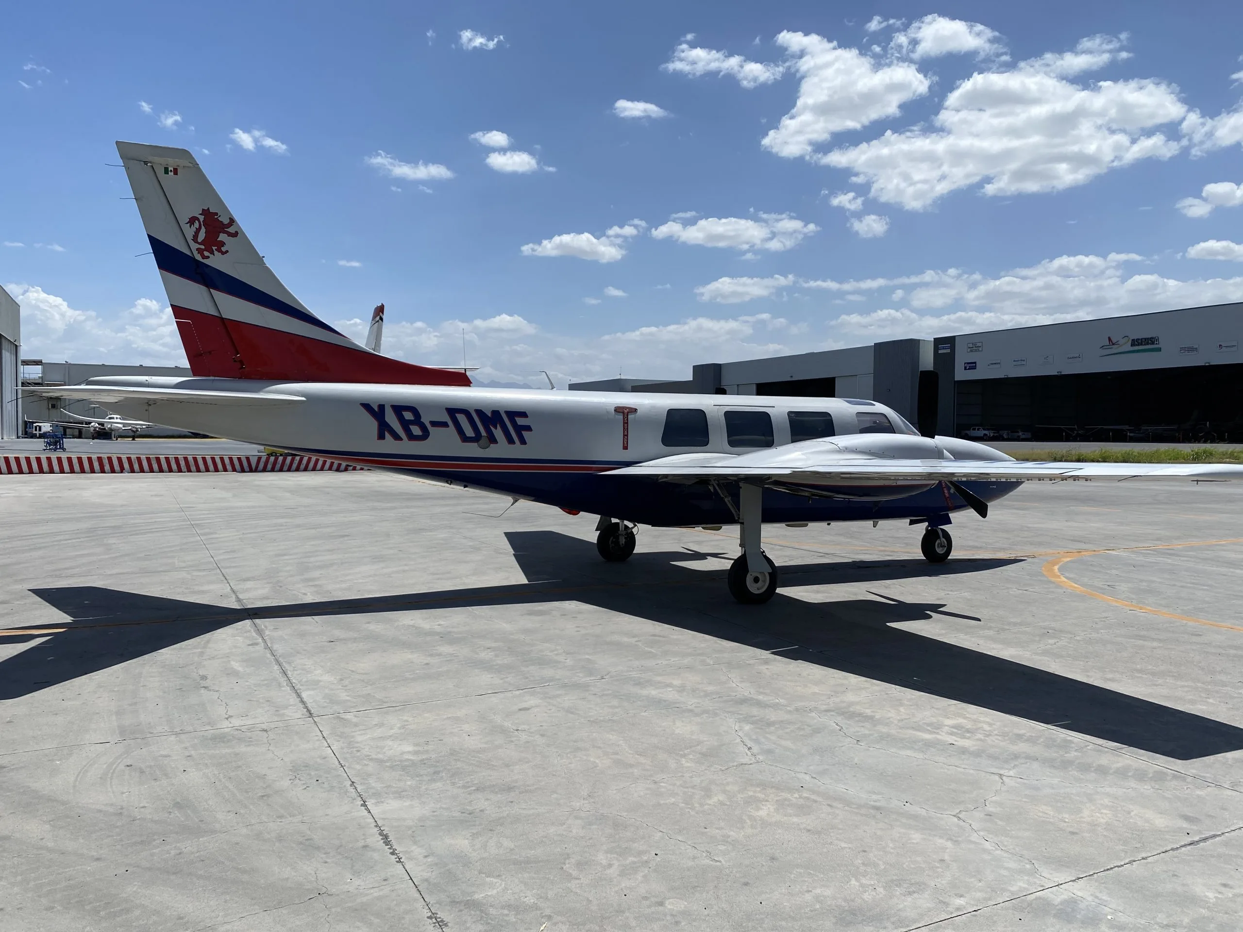 Side view of the XB-DMF aircraft parked on the tarmac.