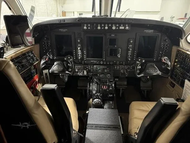 The cockpit of a Beechcraft King Air 350i, featuring a modern glass panel display and dual yokes.