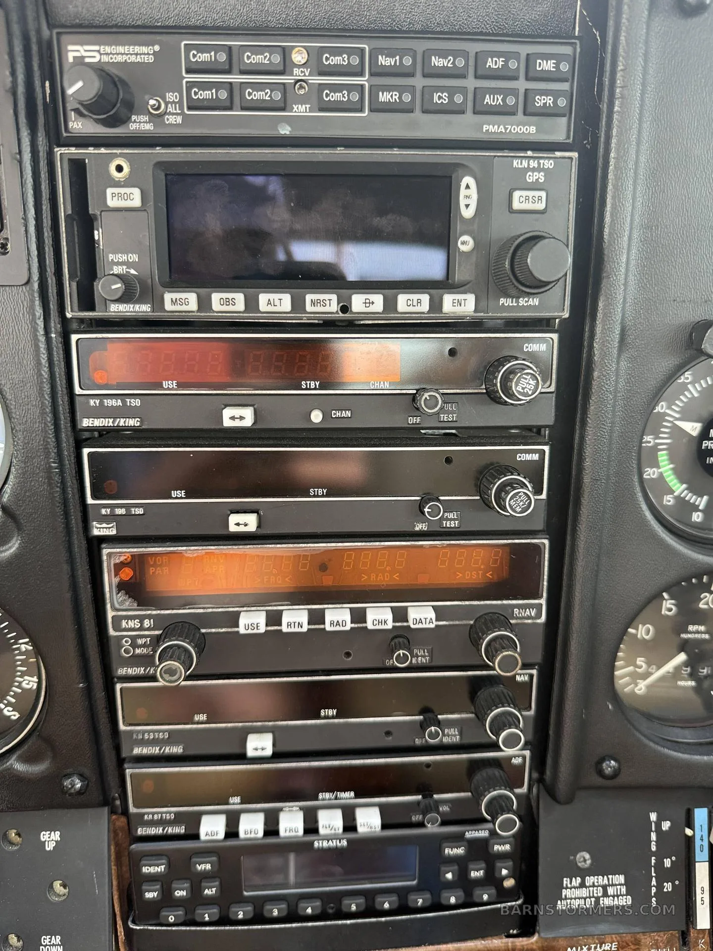 A close-up view of the avionics stack in a light aircraft cockpit, showing various radios and navigation units.