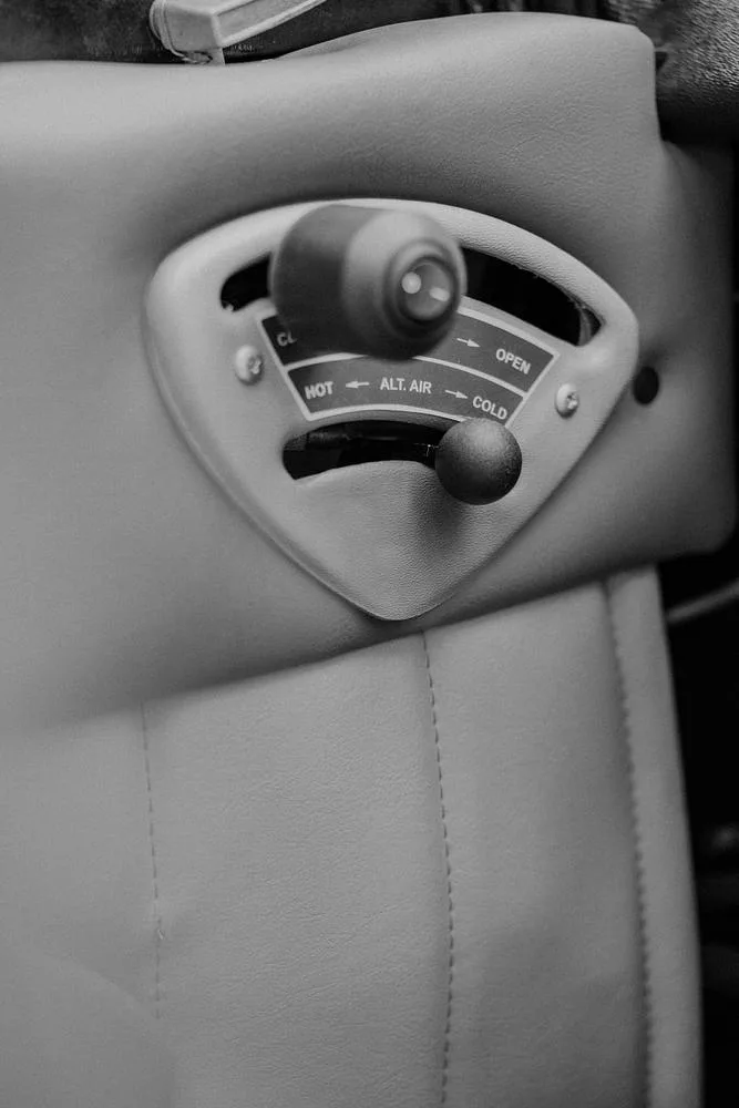 A black and white close-up of an aircraft's air control panel with "HOT", "ALT. AIR", and "COLD" labels.