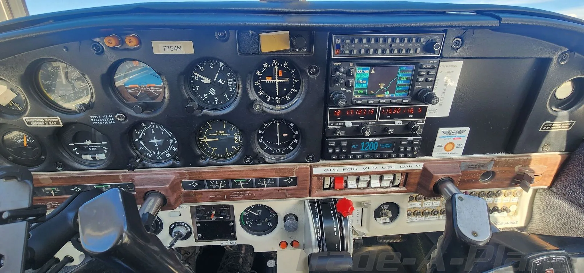 The instrument panel of a Piper Cherokee 140, showing analog gauges and modern avionics.